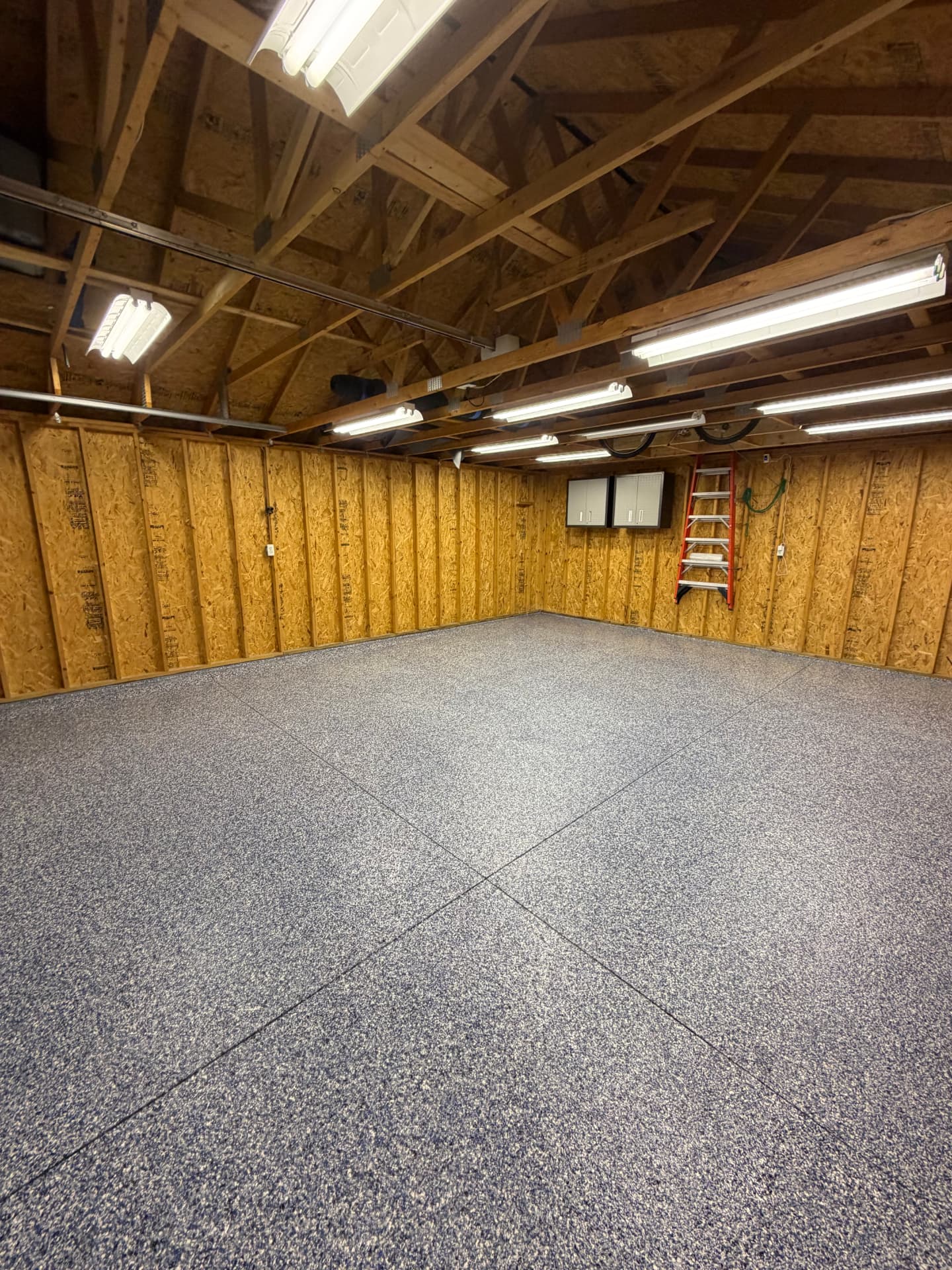 Bare concrete garage floor transformed into a flake epoxy floor